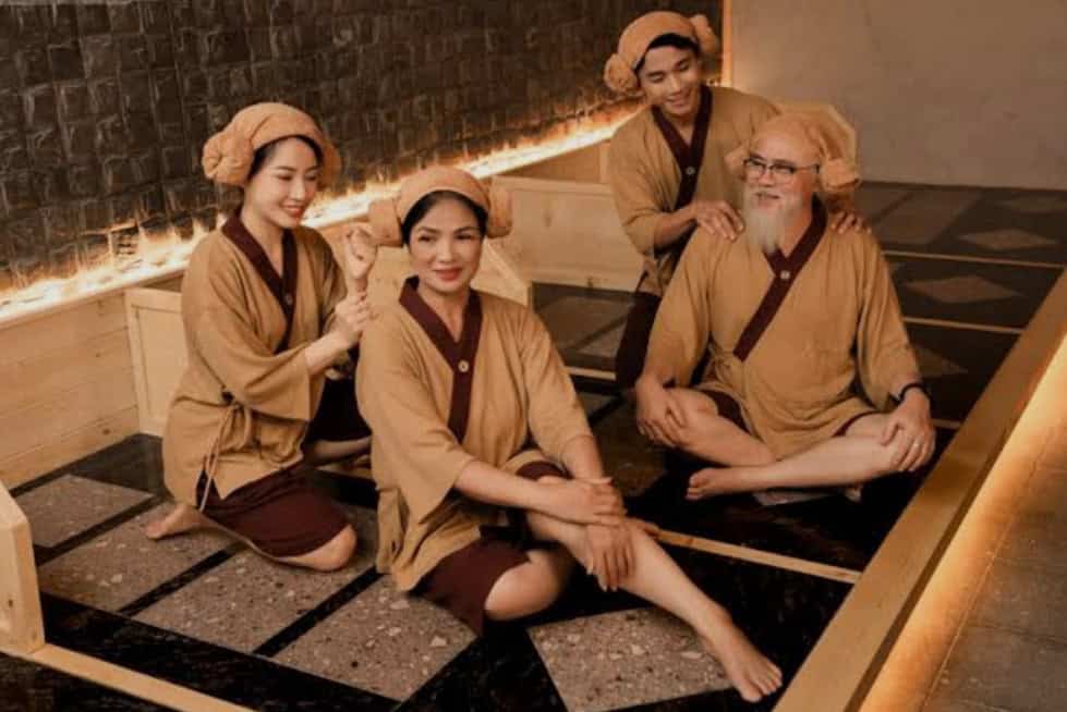 Relaxing traditional Korean spa with cultural attire, showcasing wellness and relaxation at Annyeong India.